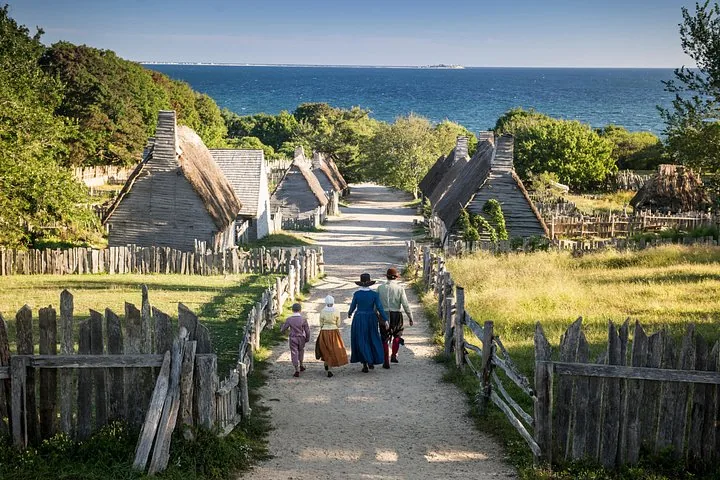 A path leading through a historical village towards the sea.